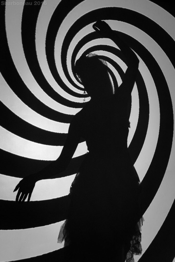 A spiral was being projected onto a wall/background creating a silhouette.